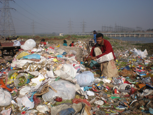 Rag pickers pick up plastic at a waste dump site in Delhi